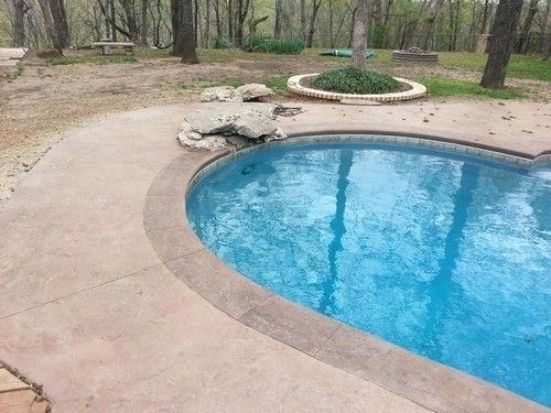 Expansive pool area with a stamped concrete deck [Design: L